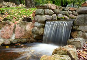 Gorgeous waterfall with stone retention wall