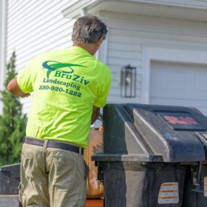 BruZiv employee dumping lawn debris