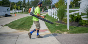 BruZiv worker with leaf blower cleaning up commercial property after landscaping maintenance