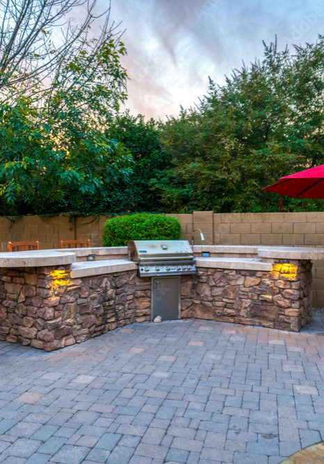 Outdoor wrap around stone countertops and bar with built-in grill