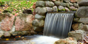 gorgeous waterfall with stone retention wall