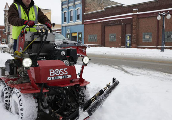 commercial snow removal with rideable sidewalk plow